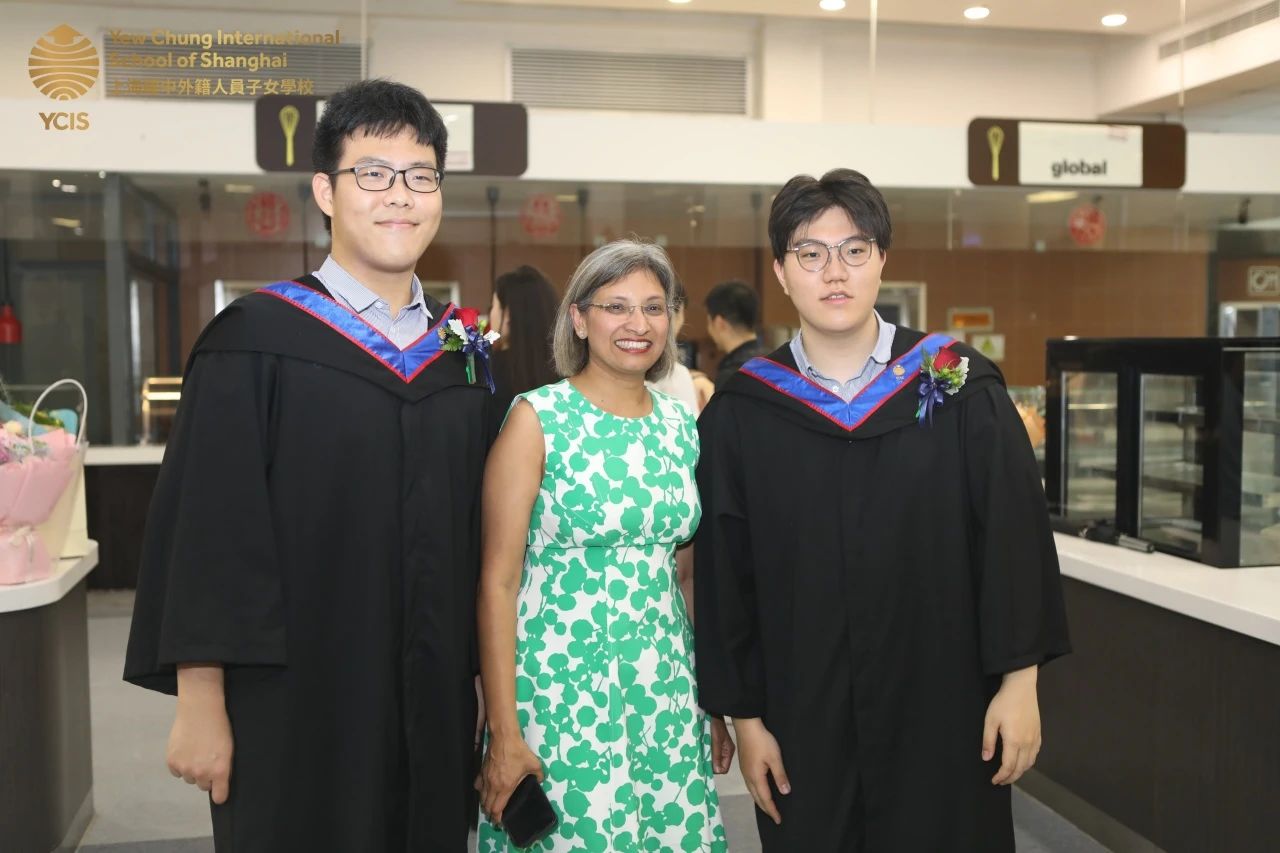 Brian (far right) and Ms Priya Williams at the graduation ceremony